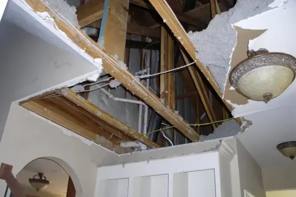 Ceiling opened to the joists after a leak from above soaked the drywall